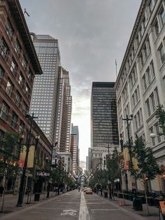 an empty city street lined with tall buildings