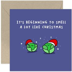 a christmas card with two green heads wearing santa hats and the words it's beginning to smell a lot like christmas