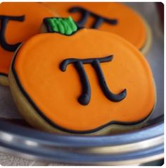 three decorated cookies with the letter t on them