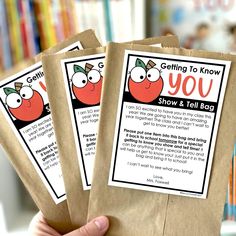 three brown paper bags with instructions for getting to know you show and tell bag in front of bookshelf