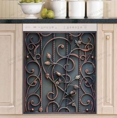 a kitchen with white cabinets and an ornate iron grill in front of the counter top