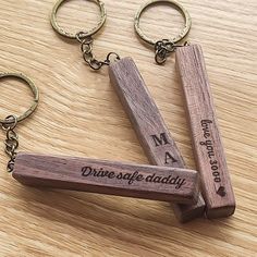 two wooden keychains that say, drive safe daddy and make me happy on them