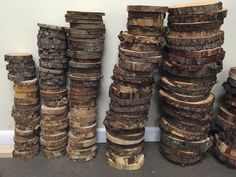 several stacks of wood stacked on top of each other in front of a white wall