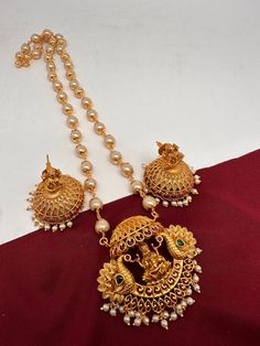 Goddess Lakshmi Peacock Pendent Set with Pearl Mala and Matching Jhumki Simple dainty Pendent Sets for any occasion. It comes with pearl mala but can be used with any gold chain or beads too, Pendent Length Approx. 2 Inches Pearl Mala Length : Approx. 24 Inches;  Earring Length : Approx. 1.5 Inches; Push back. Ready to ship from Boston, MA Delivery time 3-5 days. If you have any questions please let me know. Thank you!! Traditional Festive Jewelry Set With Pearl Pendant, Festive Traditional Jewelry Set With Pearl Pendant, Diwali Temple Jewelry Set With Pearl Drop, Temple Jewelry Sets With Pearl Drop For Festivals, Temple Jewelry Sets With Pearl Drop For Festive Season, Temple Jewelry Sets With Pearl Drop For Festive Occasions, Festive Jewelry Sets With Pearl Pendant For Celebration, Festive Diwali Pearl Drop Jewelry Sets, Festive Pearl Pendant Jewelry Set For Celebration