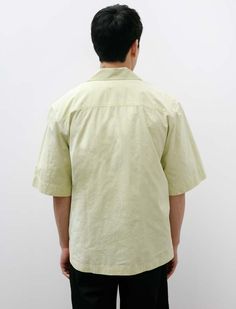 An oversized cropped half-sleeve button-front shirt cut from a lightweight crisp cotton canvas in soft shade of pale yellow. features a convertible collar a large left breast pocket with a flap closure a clean-finished rear yoke and a flat hem with split side seams. the generous proportions through the body and sleeves create a strong silhouette that is softened by a uniquely relaxed sensibility to create a very pleasing final look. durably constructed with chain stitched flat-felled seams throu Spring Solid Cotton Camp Shirt, Yellow Cotton Camp Shirt With Relaxed Fit, Yellow Cotton Relaxed Fit Short Sleeve Shirt, Yellow Relaxed Fit Cotton Short Sleeve Shirt, Yellow Cotton Short Sleeve Shirt With Relaxed Fit, Flat Felled Seam, Convertible Collar, Margaret Howell, Mens Button Up