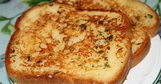 two pieces of toast sitting on top of a green and white plate next to each other