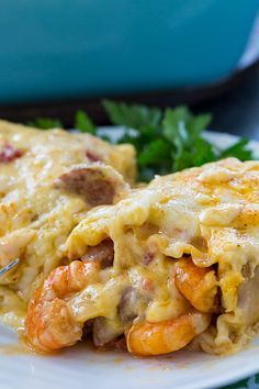 a white plate topped with lasagna covered in meat and cheese