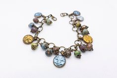 Artisan charm bracelet, with Czech beads and polymer clay face pendants. Bohemian, hippy, gift for her. Polymer Clay Face, Tarpon Springs, Clay Face, Clay Faces, Czech Beads, Bead Designs, Charm Bracelets, Springs, Jewelry Bracelets