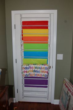 a room with a door that has many different colored blinds on it