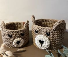 two crocheted baskets with faces on them