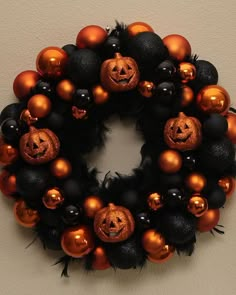 a halloween wreath with pumpkins and black balls