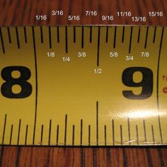 a yellow measuring tape with the number nine on it's side and numbers in black