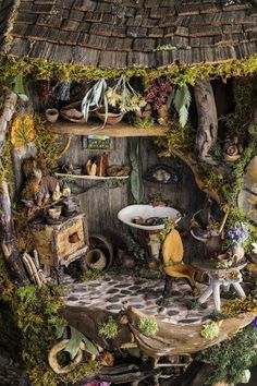 a doll house with lots of plants and animals on the shelves in front of it