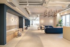 an empty office with blue couches and white walls