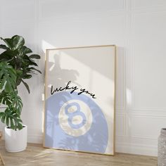 a poster with the number eight on it next to a potted plant and a white wall