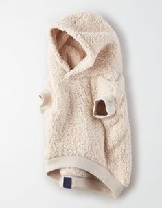 a white dog coat with a hoodie on it's back and an attached collar