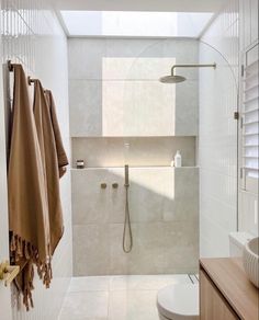 a bathroom with a shower, toilet and sink