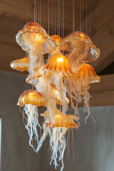 a bunch of jellyfish hanging from a ceiling