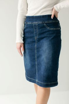 Simple lines, classic and comfortable, the 'Sara' is everything a denim skirt should be. This skirt is made from a quality stretch denim and is as comfy as they come! Featuring a wide waistband for extra comfort and ease of styling. Exclusively designed by us for you. 85% Cotton 12% Polyester 3% Spandex Machine Wash Cold Do Not Bleach Hang to Dry Low Iron if Needed Do Not Dry Clean Functional Back Pockets Available in 21" ,24", and 26" length Model A Height 5'8" | Wearing Size 10 in 26" Length M Knee Length Jean Skirt Outfits, Knee Length Jean Skirt, Modest Dress Patterns, Knee Length Jean Skirts, Long Denim Skirts, Dark Denim Skirt, Jean Skirt Outfits, Denim Shorts Outfit, Canada Fashion