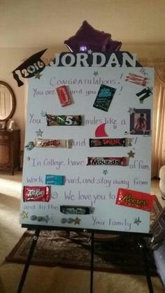 a white board with candy bars on it in front of a living room door and window