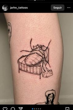 a tattoo on the leg of a person with an insect sitting on top of it