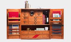 an open bookcase with drawers and shelves filled with books