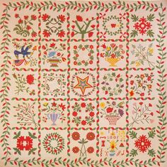 an old fashioned quilt with flowers and birds on the front, along with other designs