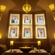 a table with candles and pictures on the wall