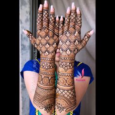 a woman holding her hands up to show the hendi design on her hand and wrist