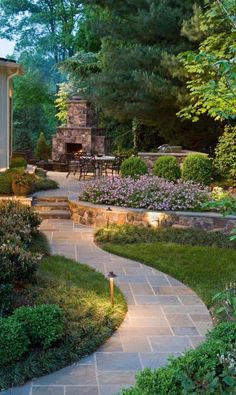 an outdoor patio with stone steps and landscaping