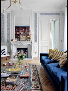 a living room filled with furniture and a fire place