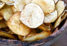 a bowl filled with sliced up potato chips