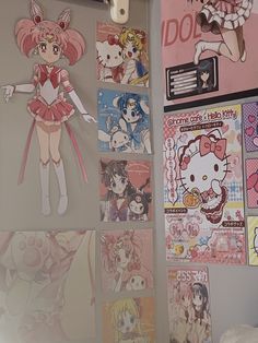 the wall is covered with anime posters and drawings