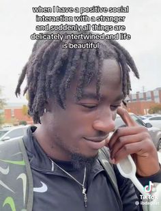 a man with dreadlocks talking on a cell phone