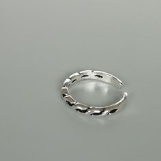 A sterling silver toe ring with twists.. 2mm wide. Weight: 0.95gm This is an open ended toe ring and can be adjusted to fit most feet. These toe rings are made of 925 hypoallergenic sterling silver. Comes with an oxidized finish. Please note this price is for ONE toe ring only. Sent in a gift box. I can include a personal message from you if needed You are welcome to contact me at... bhavnakwintra1956@gmail.com For more beautiful pieces from my shop, please browse 👇 TOE RINGS: https://www.etsy. Adjustable Silver Dainty Toe Rings, Dainty Adjustable Silver Toe Rings, Minimalist Silver Hypoallergenic Toe Rings, Minimalist Hypoallergenic Silver Toe Rings, Adjustable Silver Metal Toe Rings, Trendy Sterling Silver Toe Ring, Silver Open Ring Toe Rings, Silver Metal Open Toe Rings, Trendy Silver Toe Ring