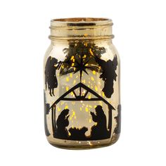 a lighted mason jar with nativity scene on it