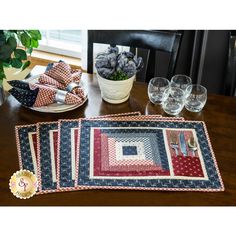 three placemats and two glasses on a table