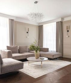 a living room filled with furniture and a chandelier