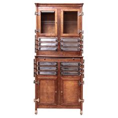 an old fashioned wooden cabinet with glass doors