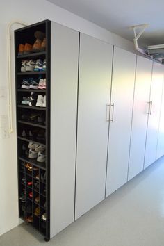 a large closet with many pairs of shoes in it