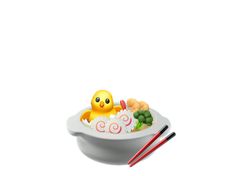 a bowl with chopsticks and a rubber ducky in it, on a white background