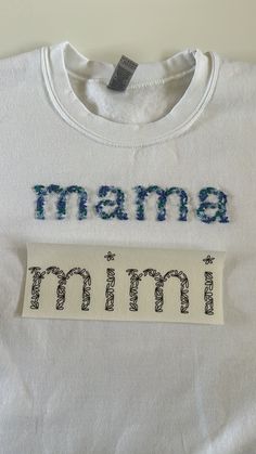 a t - shirt with the word mama on it, and an embroidered name tag