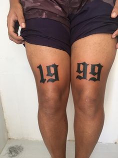 a person with black ink on their legs and the number 19 tattooed on his leg