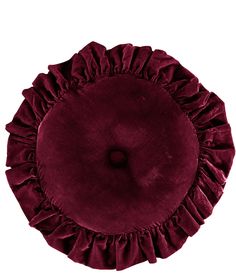 a round pillow with ruffles on the top and bottom, in maroon velvet