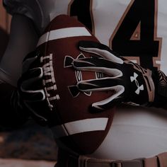 a close up of a football glove on the back of a player's uniform