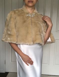 Tailored faux fur bolero , very soft gold , lined with natural heavy silk satin. High collar gives extra warmth. Slits around arm area for easy and comfortable movements. Elegant Cream Faux Fur Coat, Elegant Fur Coat With Faux Fur Trim For Wedding, Elegant Wedding Fur Coat With Faux Fur Trim, Elegant Party Fur Coat With Feather Trim, Elegant Mink Outerwear For Party, Elegant Fitted Fur Coat For Party, Faux Fur Bolero, Fur Bolero, Faux Fur Shrug