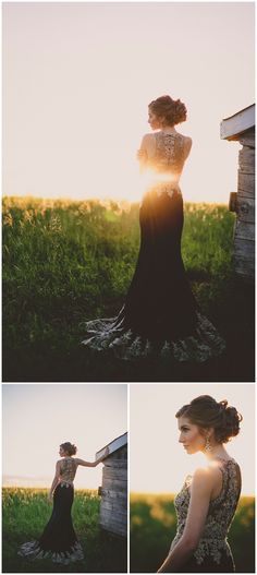 a woman in a black dress standing next to a barn and looking at the sun