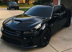 a black car parked in front of a house