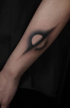 a person with a black and white tattoo on their arm