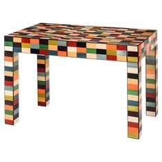 a multicolored wooden table sitting on top of a white floor